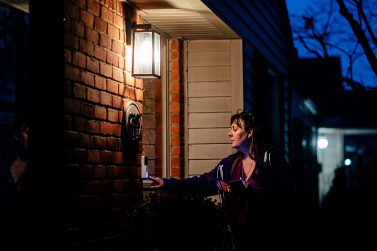 Lisa DeBlasi rings a door bell while canvassing for Reproductive Freedom For All, a group promoting abortion rights in Michigan. (Photo by Nick Hagen for The Washington Post)