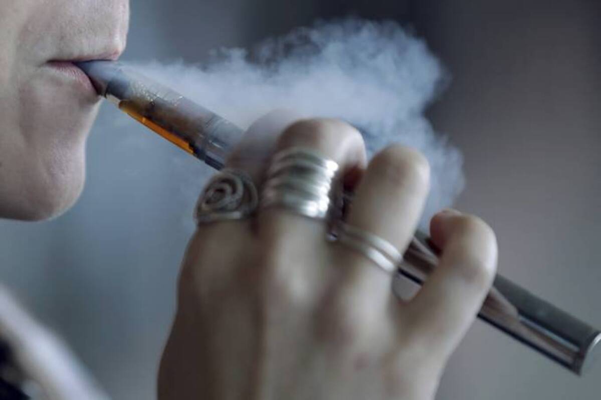 A woman using an e-cigarette. (Tony Dejak/AP)