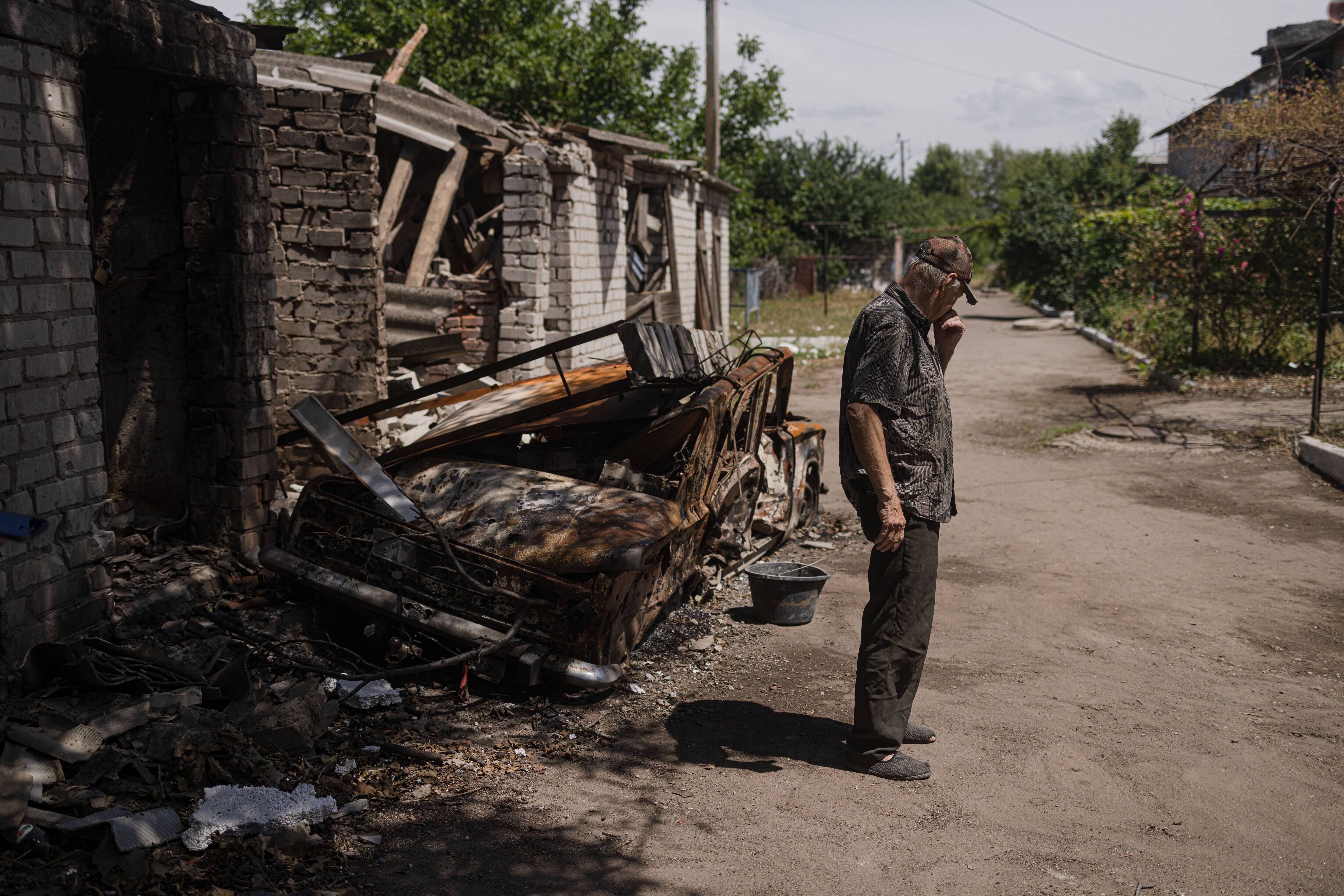 Mykola Kostitsyn, 66 near the garage that was recently hit by the Russian artillery in front of the his house in Kherson region, Ukraine, on June 25. (Serhiy Morgunov for The Washington Post)