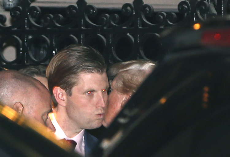Donald Trump, right, kisses his son Eric farewell after dining at the 21 Club last night in New York. (Kathy Willens/AP)</p>  