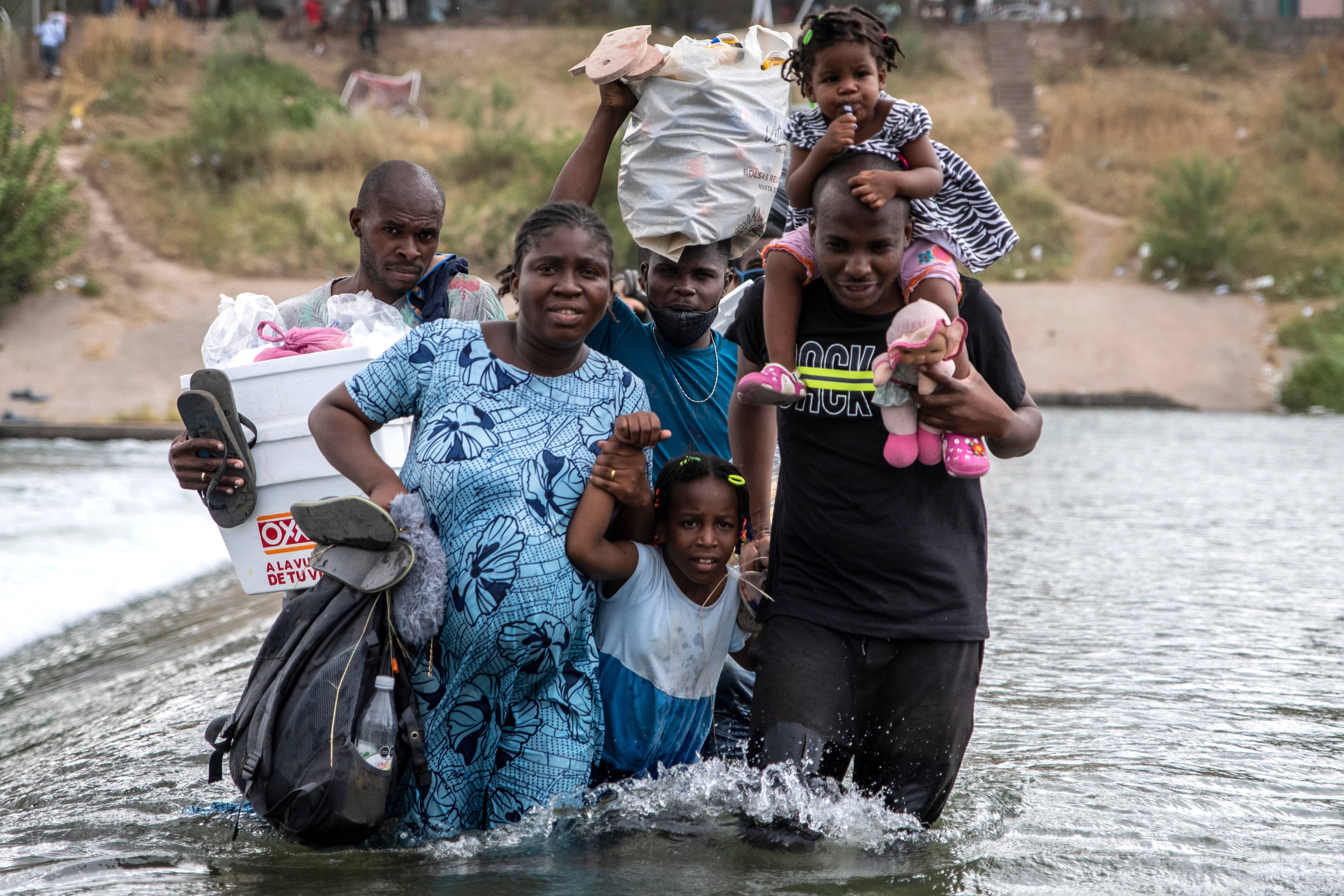 A family of migrants cross the Rio Grande in Ciudad Acuna, Mexico on Saturday. (Sergio Flores for The Washington Post)