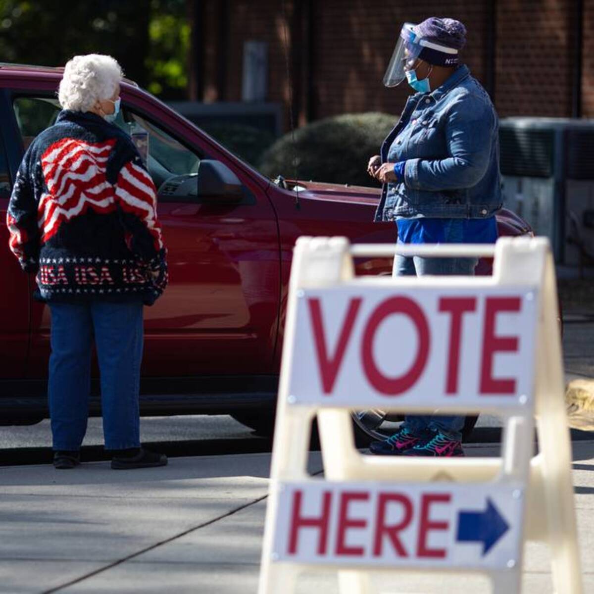 Poll workers assist a potential curbside voter at Ebenezer Baptist Church on Election Day in Charlotte, N.C. on Nov. 3, 2020. (Logan Cyrus for The Washington Post)