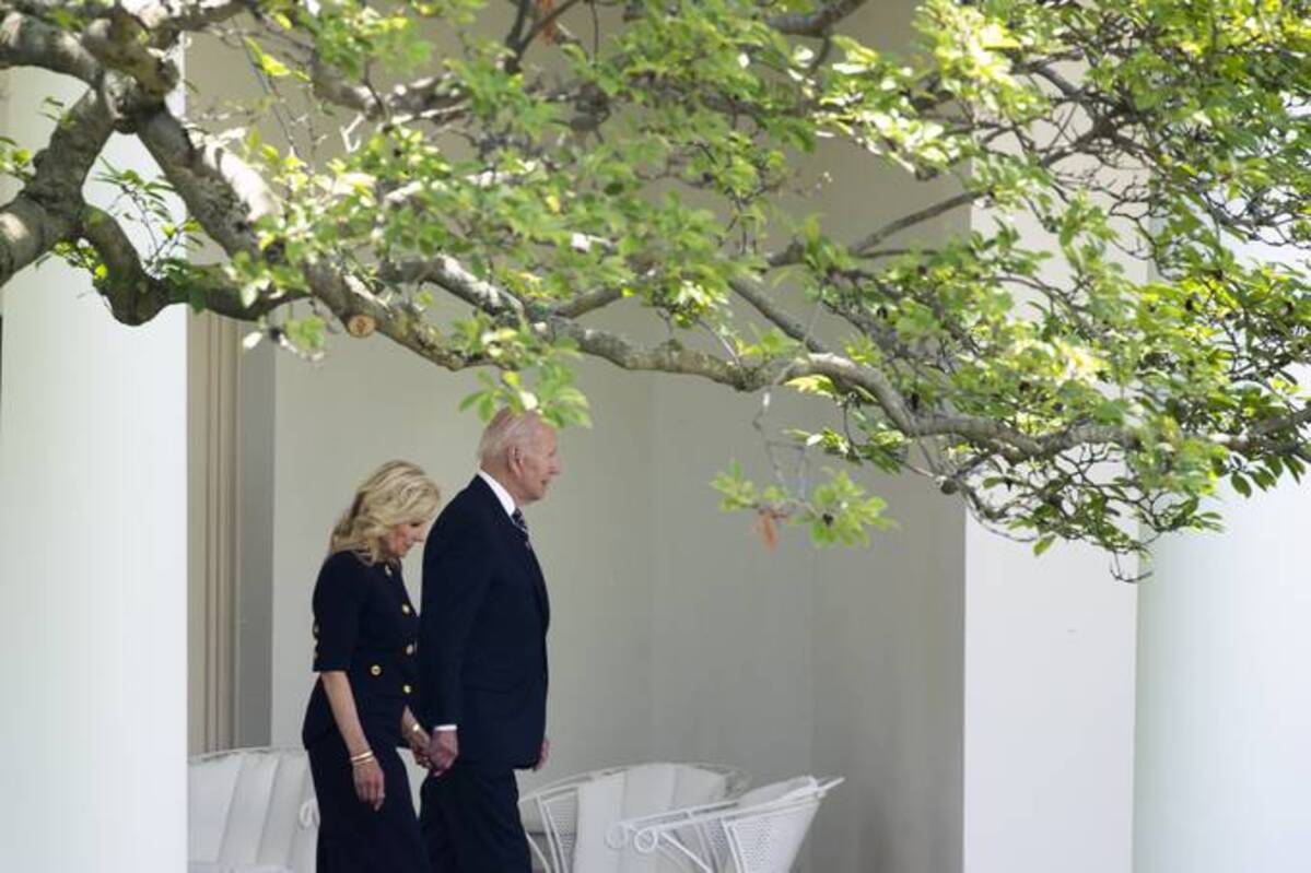 President Biden and first lady Jill Biden walk through the Colonnade on Monday before a tree-planting ceremony with surviving families of service members who have passed away. (Michael Reynolds/EPA/Bloomberg News)