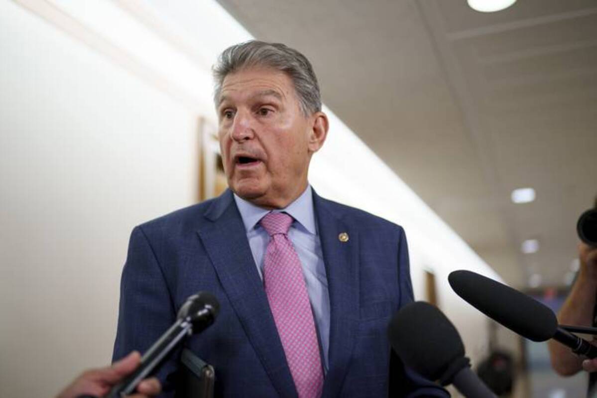 Sen. Joe Manchin (D-W.Va.) talks to reporters as he arrives to chair the Senate Energy and Natural Resources Committee, at the Capitol. (AP Photo/J. Scott Applewhite)