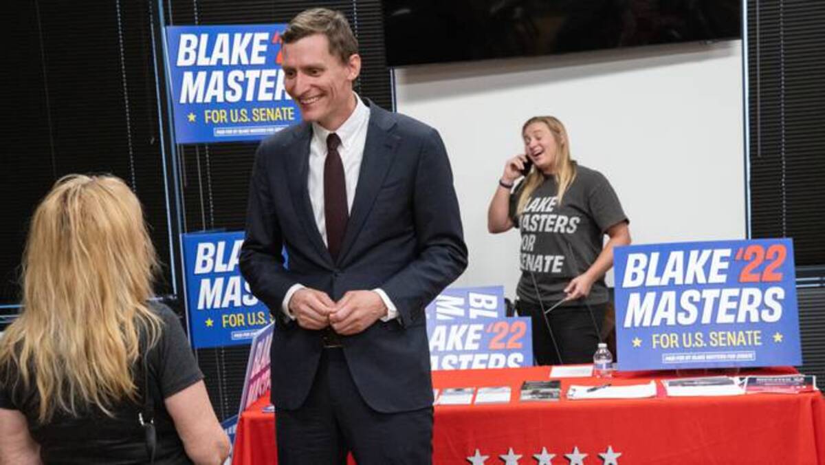 Blake Masters, Republican candidate for U.S. Senate, speaks to a voter in Buckeye, Ariz., on June 17. (Caitlin O'Hara/The Washington Post)