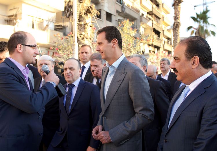 Syrian President Bashar al-Assad speaks with the press today after performing the&nbsp;Eid al-Adha prayer at a mosque in a government-controlled area of Daraya. (AFP/Ho/Sana)</p>  