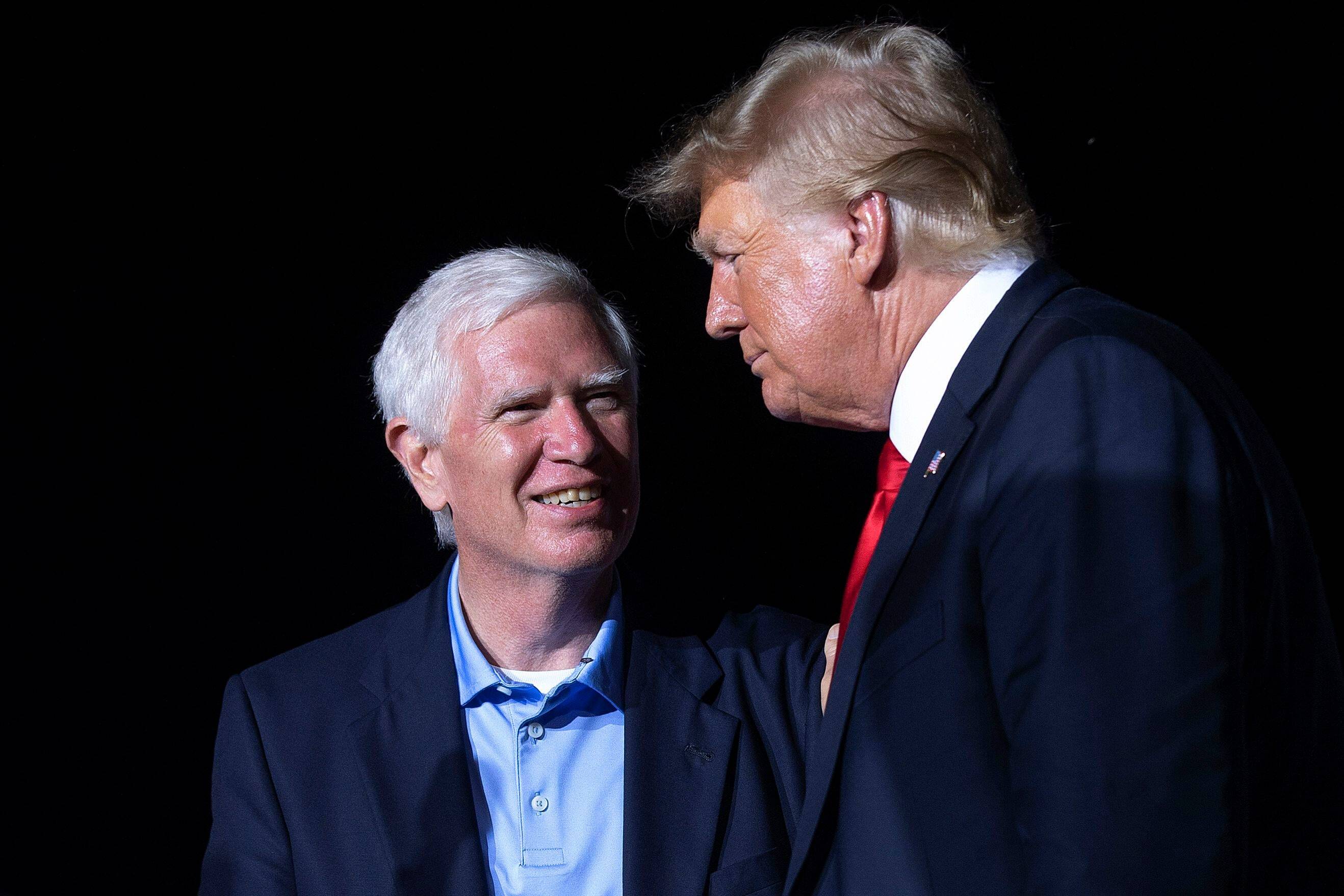 Former president Donald Trump, right, welcomes U.S. Senate candidate and U.S. Rep. Mo Brooks (R-Ala.) to the stage during a rally in Cullman, Ala., on Aug. 21, 2021. (Photo by Chip Somodevilla/Getty Images)