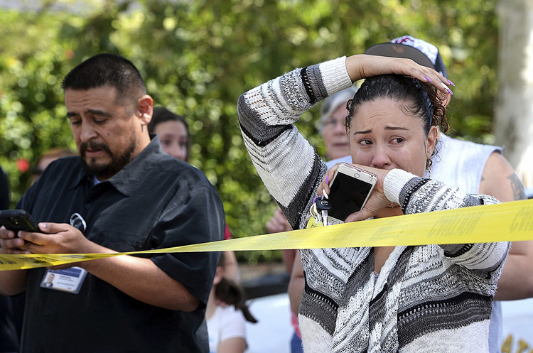 Parents wait outside North Park Elementary School to learn if their children are still alive after a shooting inside. (Rick Sforza/Los Angeles Daily News via AP)</p>