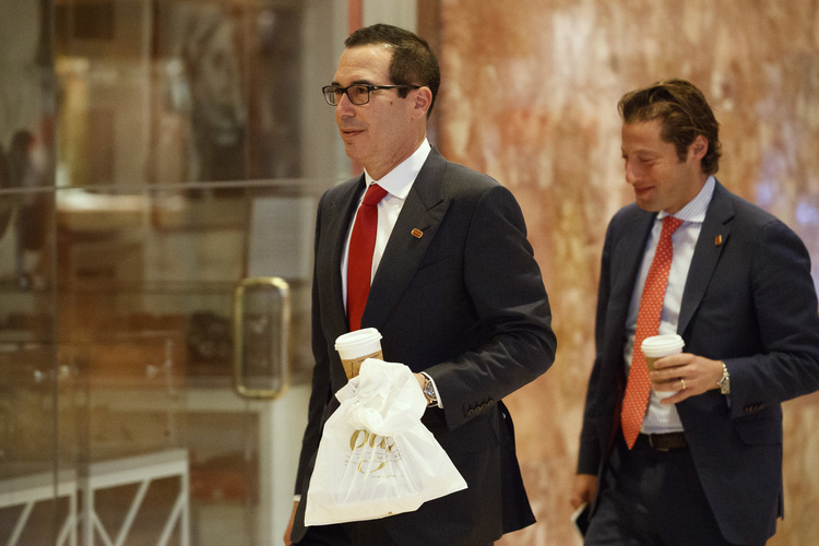 Steven Mnuchin, left, and Eli Miller, chief operating officer of the Trump campaign, walk into the lobby of Trump Tower yesterday. (Evan Vucci/AP)</p>  