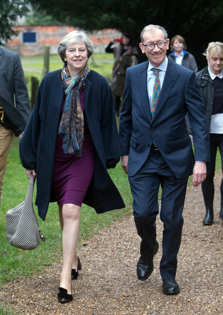 Theresa May and her husband, Philip, leave St Andrew's Church following a Christmas service. (Steve Parsons/PA via AP)</p>