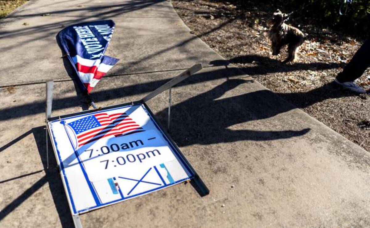 On the first day of early voting for the Jan. 5 Senate runoff, a cold wind blows down 