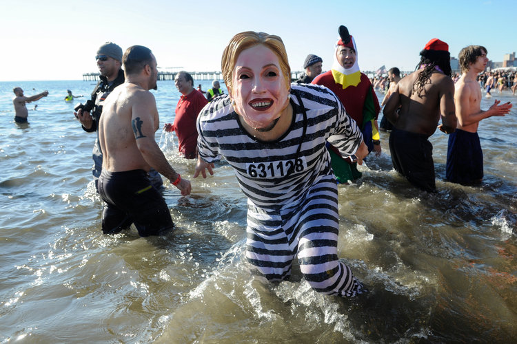 A woman wearing a Hillary mask participates in the annual Polar Bear Plunge in Coney Island on New Year's Day. (Stephanie Keith/Reuters)</p>  