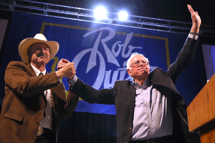 Rob Quist and Bernie Sanders greet supporters during a rally in Butte. (Justin Sullivan/Getty)</p>