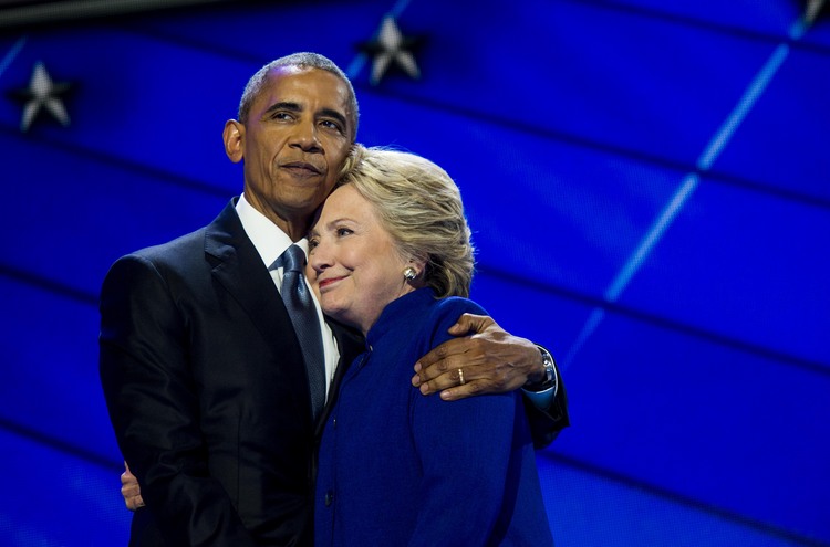 Barack Obama hugs Hillary Clinton at the Democratic National Convention in Philadelphia on July 27. He is returning&nbsp;to the city today&nbsp;to stump on her behalf. (Photo by Melina Mara/The Washington Post)</p>  