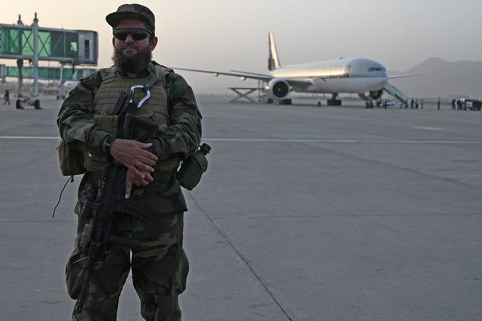 A member of the Taliban Badri 313 military unit stands guard as passengers board a Qatar Airways aircraft bound to Qatar at the airport in Kabul on September 10. (Aamir Qureshi/AFP)&nbsp;