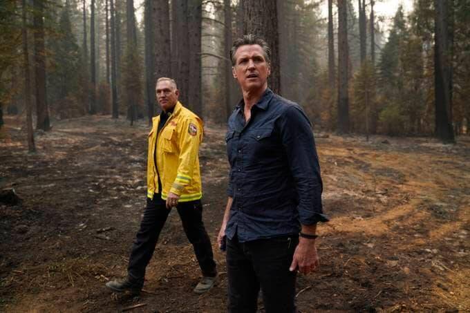 Gov. Gavin Newsom (D-Calif.), center, and Cal Fire Chief Thom Porter tour the area scorched by the Caldor Fire in Eldorado National Forest on Wednesday. (Jae C. Hong/AP)