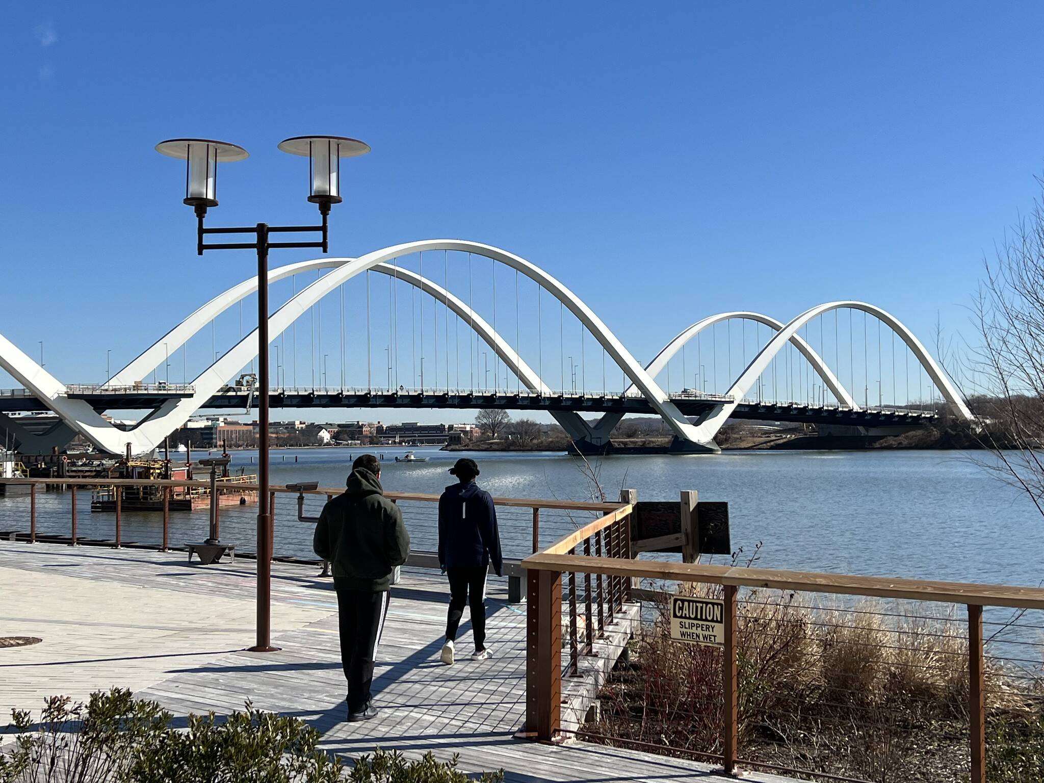 Sky mostly blue over the Anacostia Riverwalk Trail and Douglass Bridge (Jeannie In D.C./Flickr)