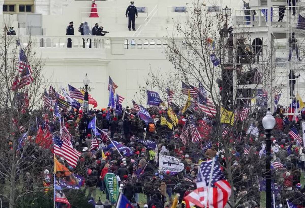 Capitol Police officers monitor protestors as they gather outside the Capitol on Jan. 6, 2021. Shortly afterward rioters breached the building. (Photo by Bonnie Jo Mount/The Washington Post)
