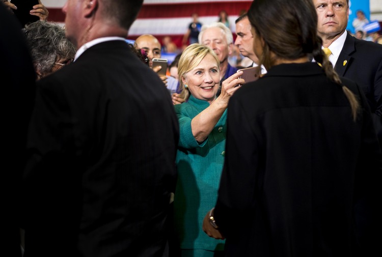 &nbsp;Clinton takes pictures and meets Iowa voters during a rally at Lincoln High School in Des Moines. (Melina Mara/The Washington Post)</p>  