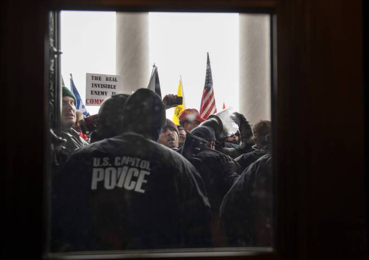 Protesters fight to gain access to the U.S. Capitol during a joint congressional session to certify the electoral college vote in Washington, D.C on Wednesday, January 6, 2021. (Amanda Voisard/for The Washington Post)