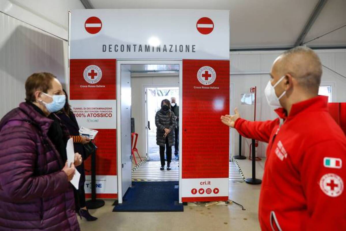 Visitors pass a decontamination area as they enter a coronavirus vaccination center outside Rome's Termini railway station. (Alessia Pierdomenico/Bloomberg News)