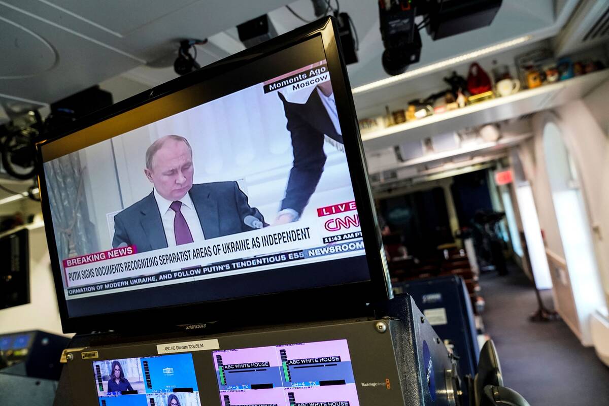 Russian President Vladimir Putin appears on a screen at the White House briefing room, as he signed documents recognizing separatist areas of Ukraine as independent, in Washington on Feb. 21. (Joshua Roberts/Reuters)