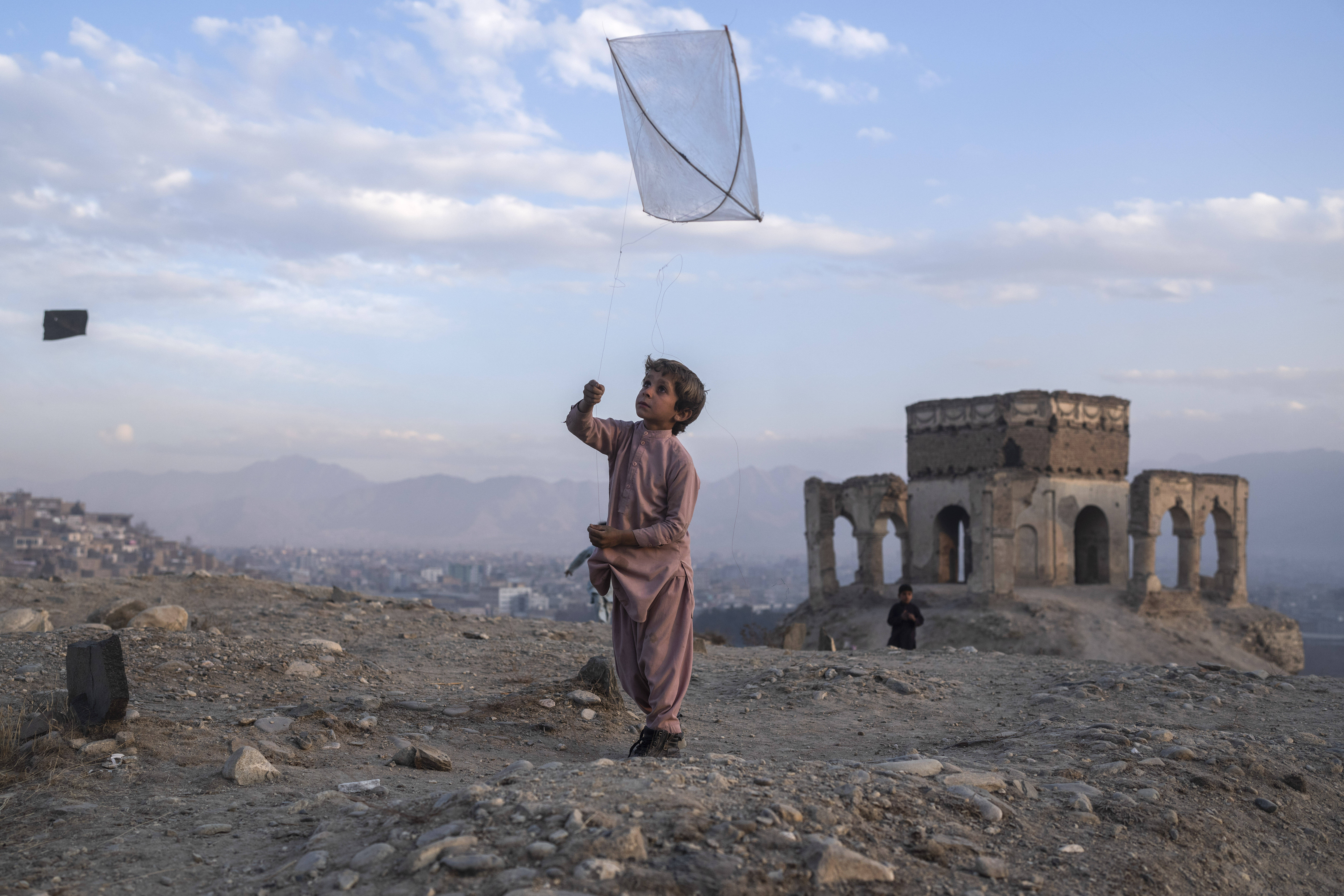 A boy flies a kite in Kabul on Dec. 4. (Petros Giannakouris/AP)