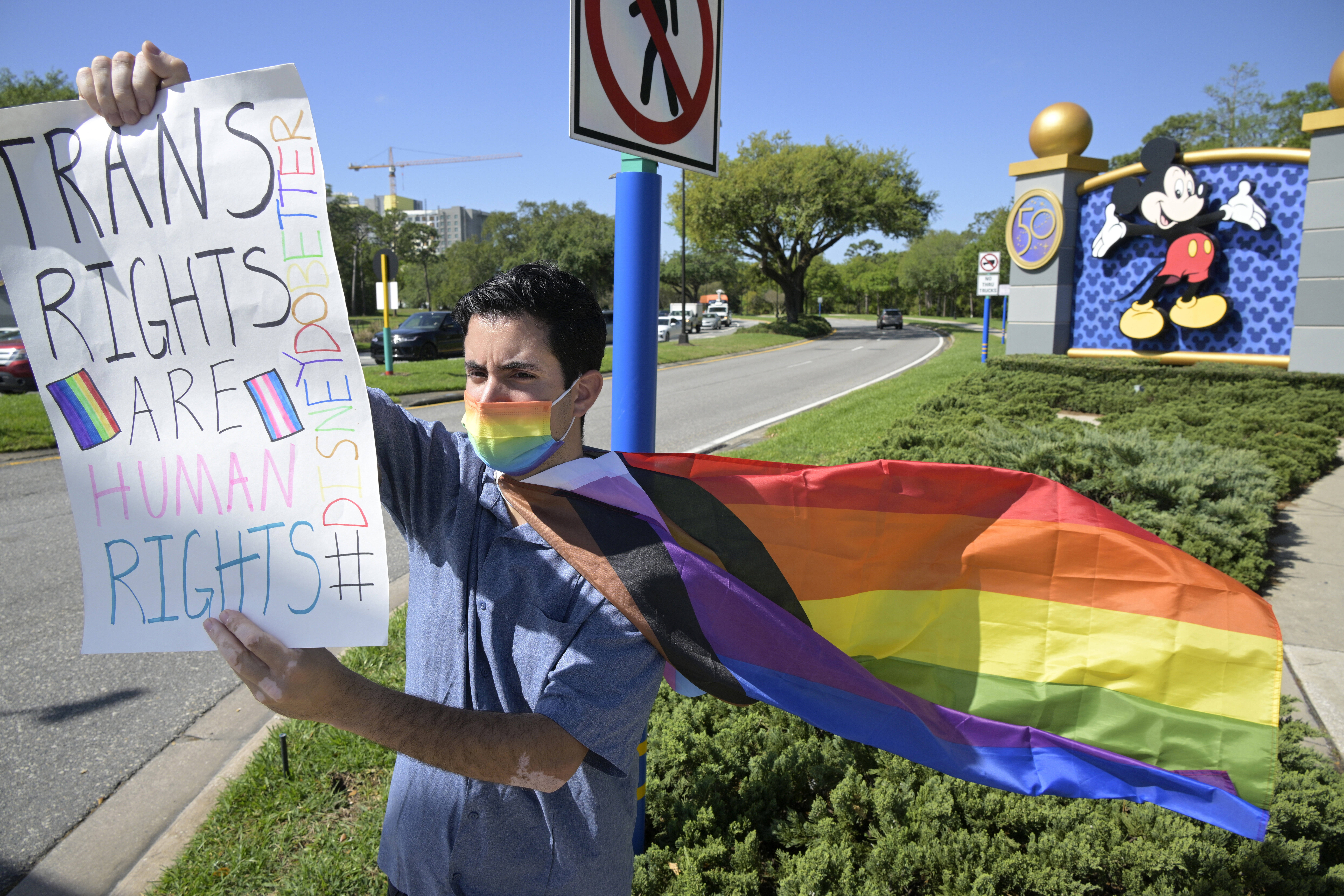 Disney cast member Nicholas Maldonado protests how long it took Disney to oppose Florida's new LGBTQ legislation during a March employee walkout at Disney World in Lake Buena Vista, Fla. (Phelan M. Ebenhack/AP)