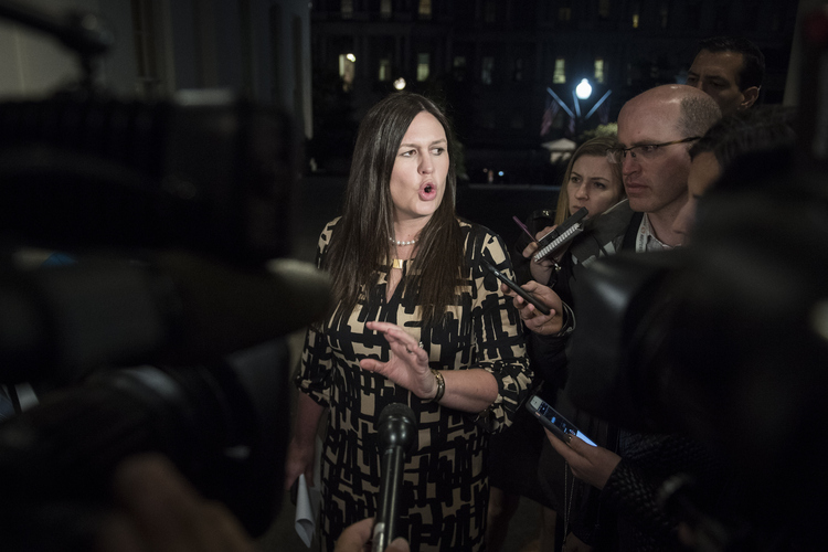 White House deputy press secretary Sarah Huckabee Sanders defends&nbsp;the president outside the West Wing last night. (Jabin Botsford/The Washington Post)</p>  