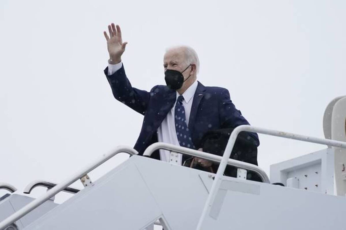 Biden waves while boarding Air Force One at Delaware Air National Guard Base in New Castle, Del., on Monday, en route to Washington. (Carolyn Kaster/AP)