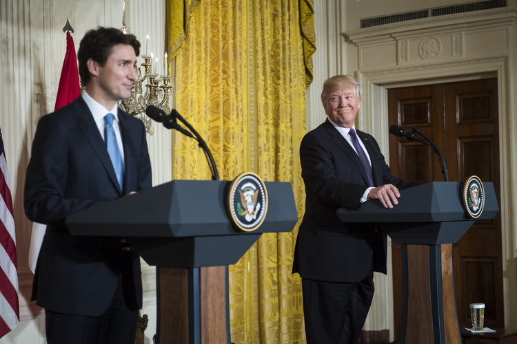Trump listens during a news conference with Canadian Prime Minister Justin Trudeau. (Jabin Botsford/The Washington Post)</p>