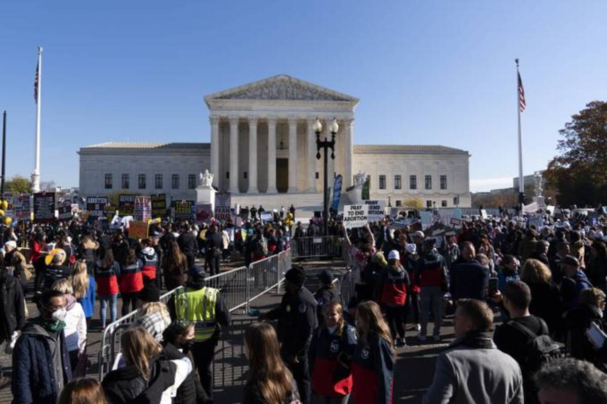 Anti-abortion and Abortion rights advocates demonstrate in front of the U.S. Supreme Court Wednesday, Dec. 1, 2021 as the court hears arguments in a case from Mississippi. (AP Photo/Jose Luis Magana)
