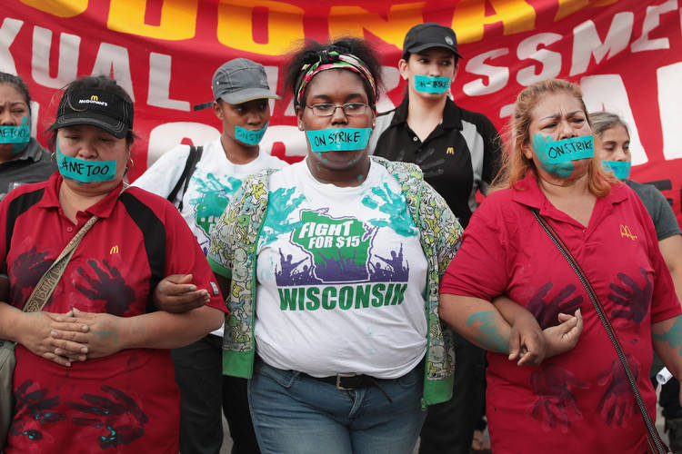 McDonald's workers are joined by other activists as they march toward the company's headquarters to protest sexual harassment at the fast-food chain's restaurants last September. (Scott Olson/Getty Images)  