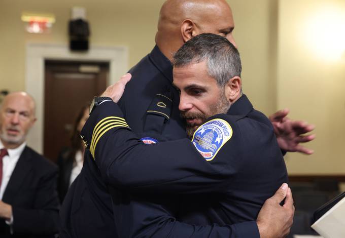 Michael Fanone, right, hugs Harry Dunn after testifying. (Jim Lo Scalzo/EPA-EFE)