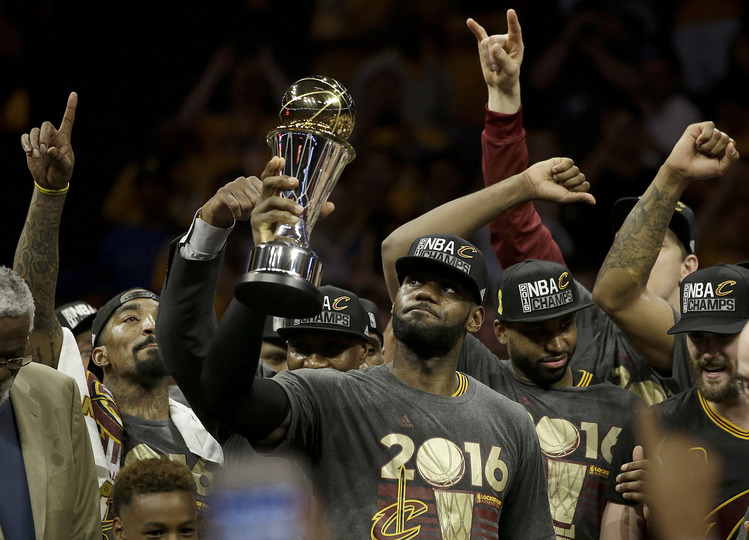 LeBron James, center, celebrates. (AP Photo/Marcio Jose Sanchez)</p>  