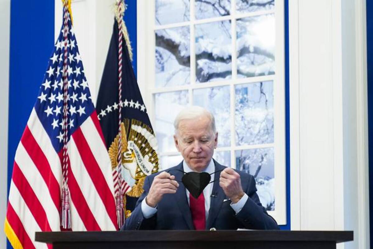 President Biden removes his face mask as he arrives yesterday to meet with the White House COVID-19 Response Team on the latest developments related to the omicron variant. (AP Photo/Andrew Harnik)