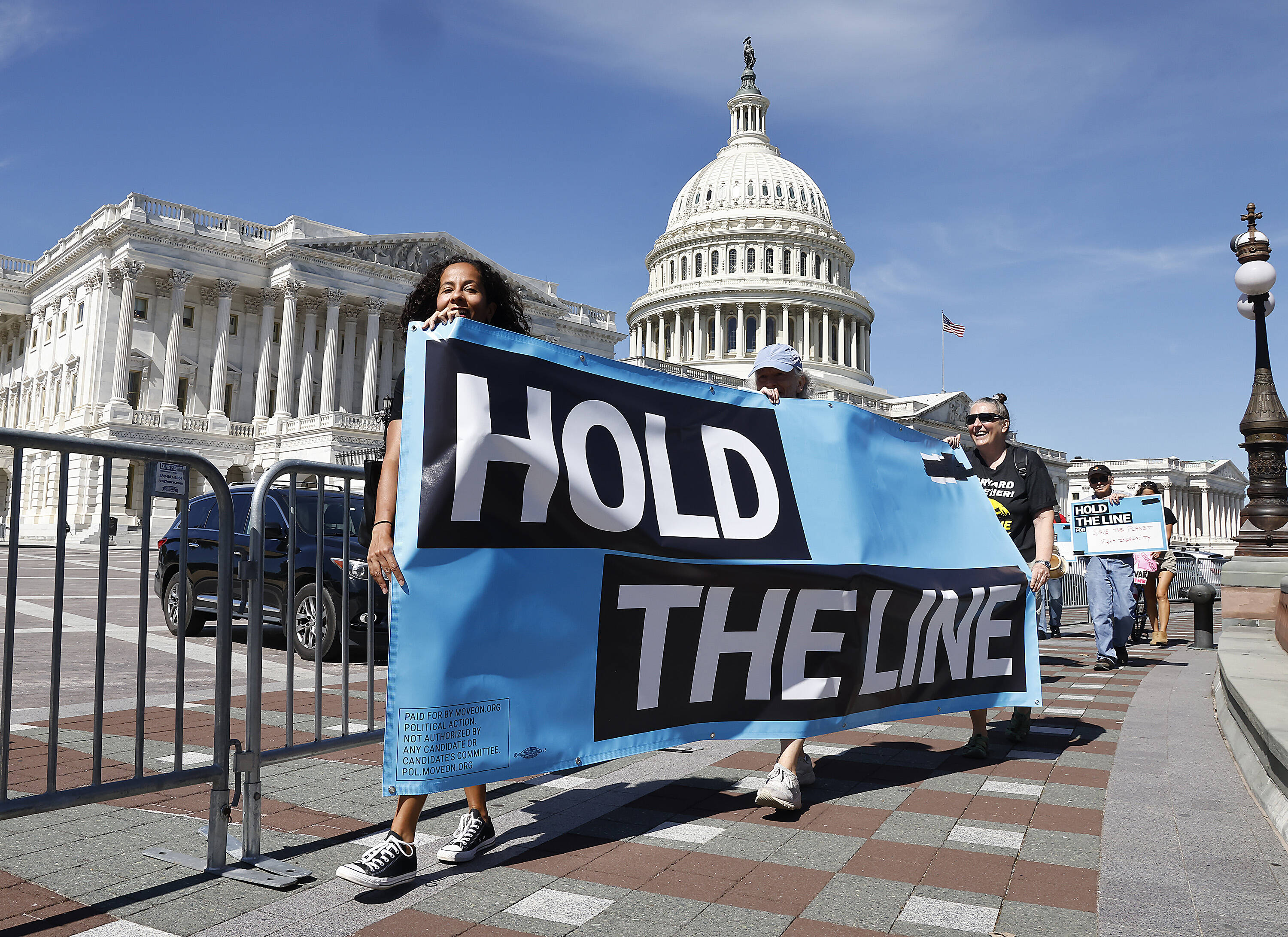 Liberal demonstrators push for Congress to pass its $3.5 trillion spending bill to expand social safety nets. (Paul Morigi/Getty Images for MoveOn)