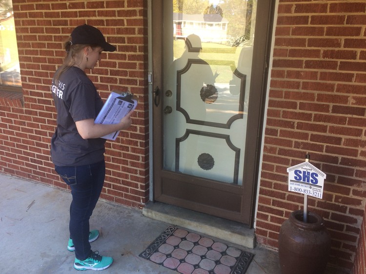 Andrea Vogler, a canvasser for Working America, knocks doors in Raleigh on Saturday. (James Hohmann)</p>  