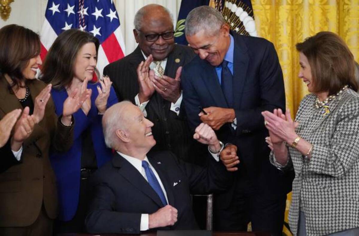 President Biden bumps fists with former president Barack Obama while signing an executive order intended to strengthen the Affordable Care Act, after delivering remarks in the East Room of the White House on Tuesday. (Mandel Ngan/AFP via Getty Images)
