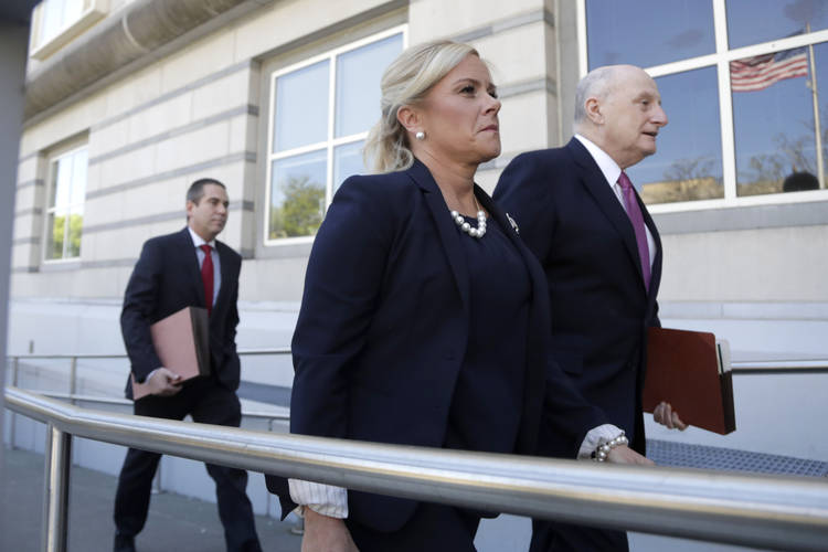 Bridget Anne Kelly, the deputy chief of staff to Chris Christie when he was governor of New Jersey, walks with her lawyer to her sentencing. She got 13 months. (Julio Cortez/AP)  