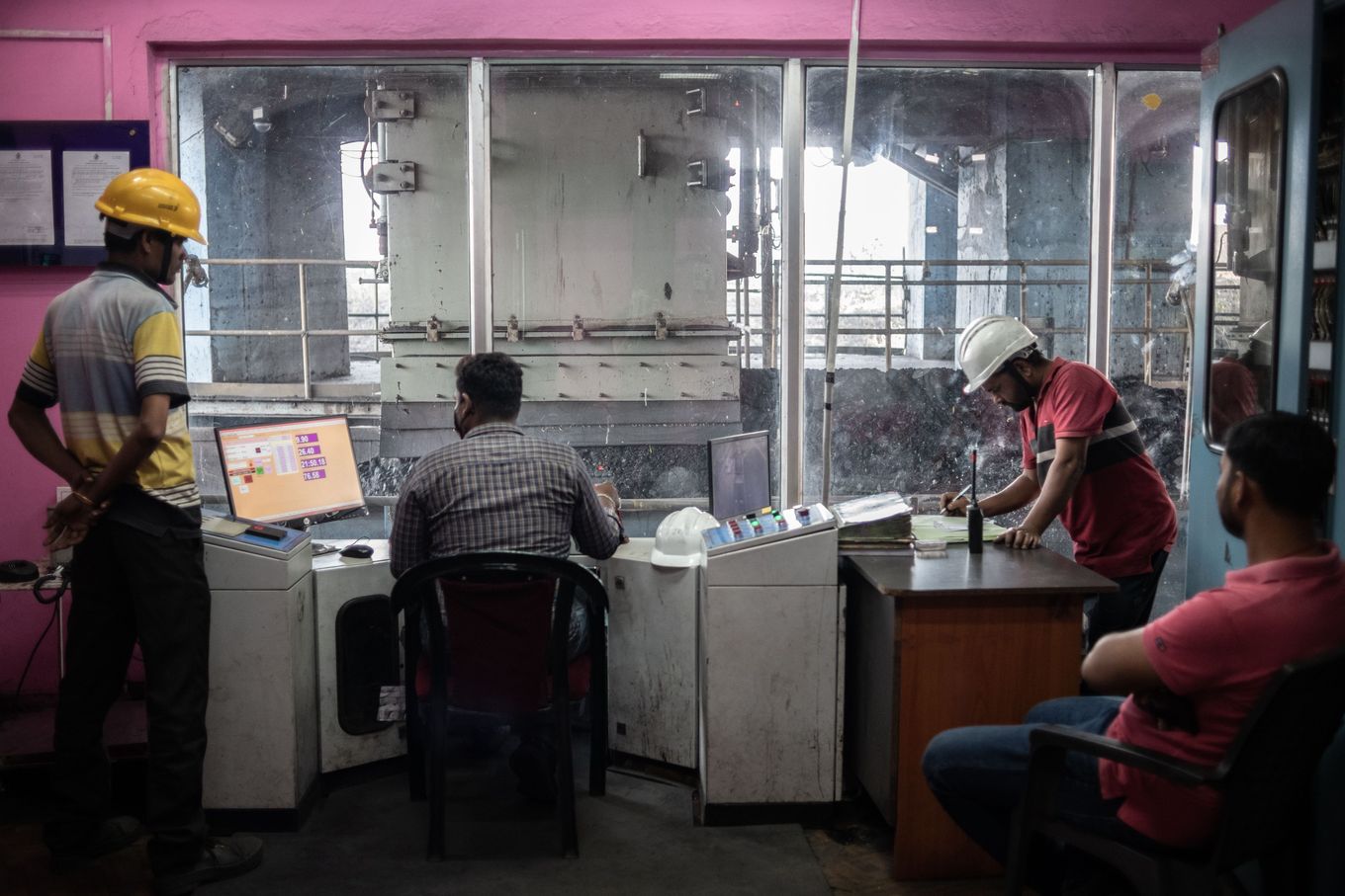 Indian mine workers load coal from a silo onto a train near the Bhubaneswari mine in Angul district in the state of Odisha on Feb. 1. (Rebecca Conway for The Washington Post)