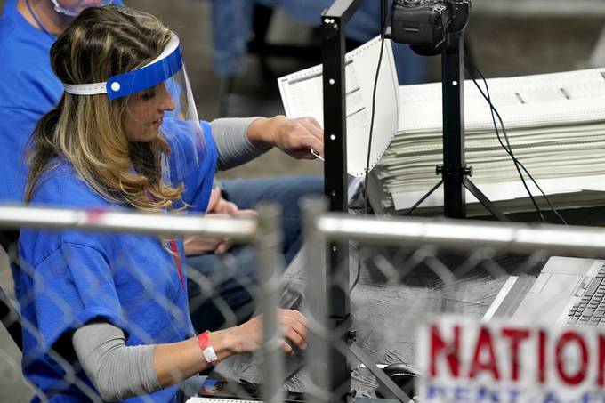 Maricopa County ballots are examined by contractors working for Cyber Ninjas. (Matt York/Pool/AP)