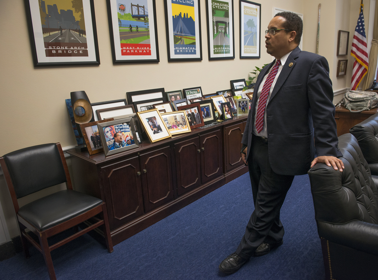 Keith Ellison looks at Minnesota memorabilia in his office on Capitol Hill. (Linda Davidson/The Washington Post)</p>  
