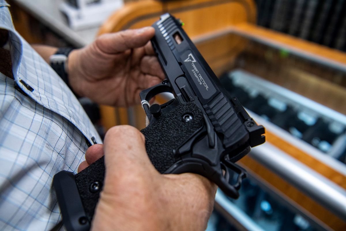 A customer checks out a hand gun that is for sale and on display at SP firearms on June 23, 2022, in Hempstead, New York. (Brittainy Newman/AP)