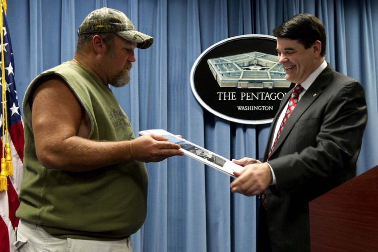 Principle Deputy Assistant Secretary of Defense for Public Affairs Bryan G. Whitman presents "Larry the Cable Guy"&nbsp;a picture and a coin in the Pentagon Briefing Room.&nbsp;(DoD photo by Erin Kirk-Cuomo)</p>  