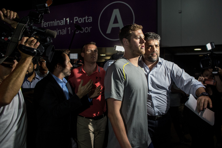 U.S Olympic swimmer Jack Conger is removed from his flight back to the U.S.&nbsp;(Chris McGrath/Getty Images)</p>  