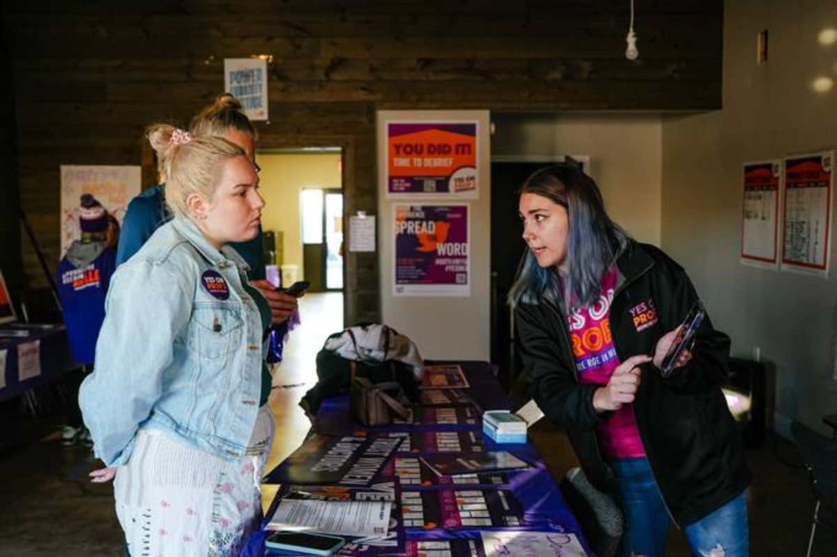 Alex Cascio, 27, an organizer with Reproductive Freedom for All in Michigan, teaches new volunteers how to use a mobile canvassing smartphone app. (Nick Hagen for The Washington Post)