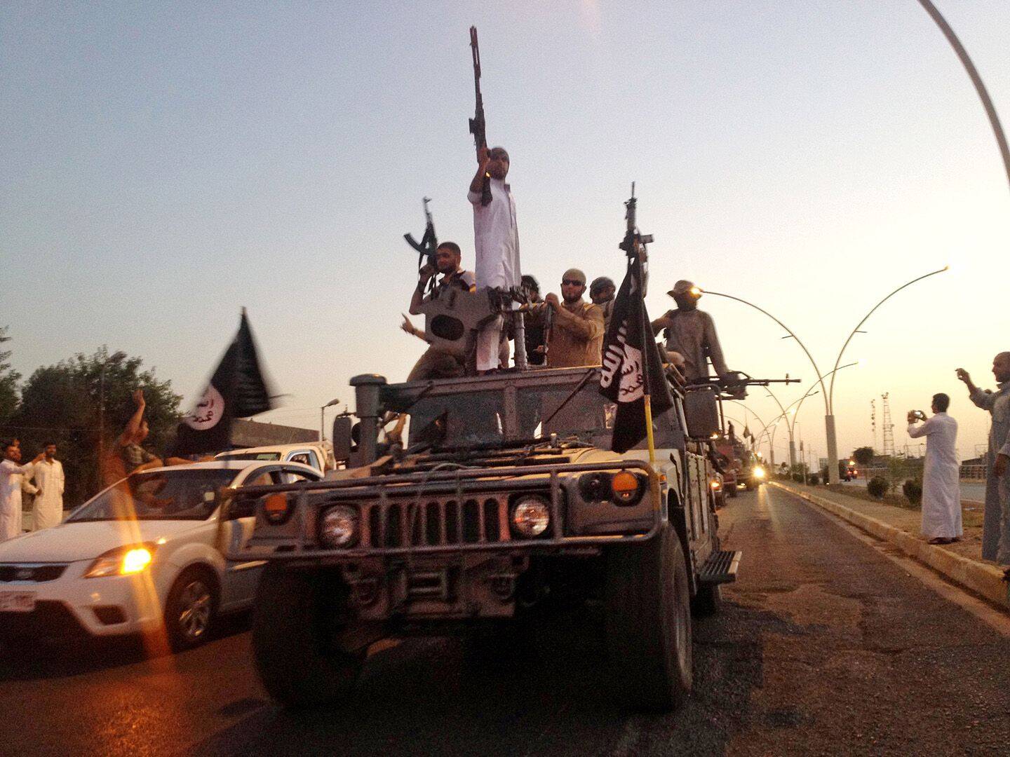 Islamic State forces parade in an Iraqi security forces armored vehicle in Mosul in 2014. (Associated Press)