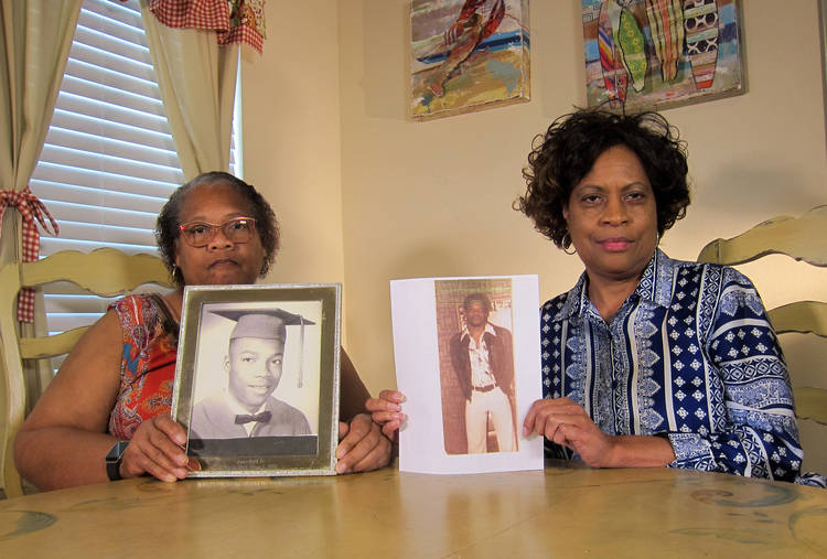 Mylinda Byrd Washington, 66, right, and Louvon Byrd Harris, 61, hold up photographs of their brother James Byrd Jr. in Houston earlier this month. James was the victim of what is considered to be one of the most gruesome hate crime murders in modern Texas history. One of his killers was put to death last night. (Juan Lozano/AP)  