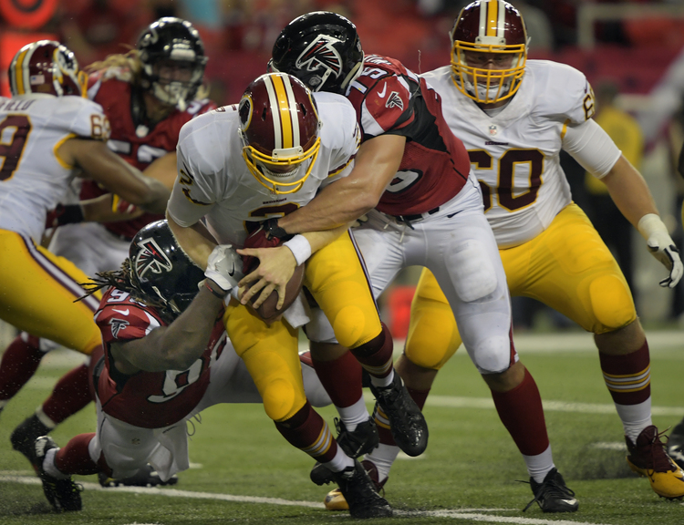 Redskins quarterback Nate Sudfeld&nbsp;is sacked last night&nbsp;by Atlanta's Nordly Capi&nbsp;and Brandon Williams in the 4th quarter.&nbsp;(Photo by John McDonnell/The Washington Post)</p>  